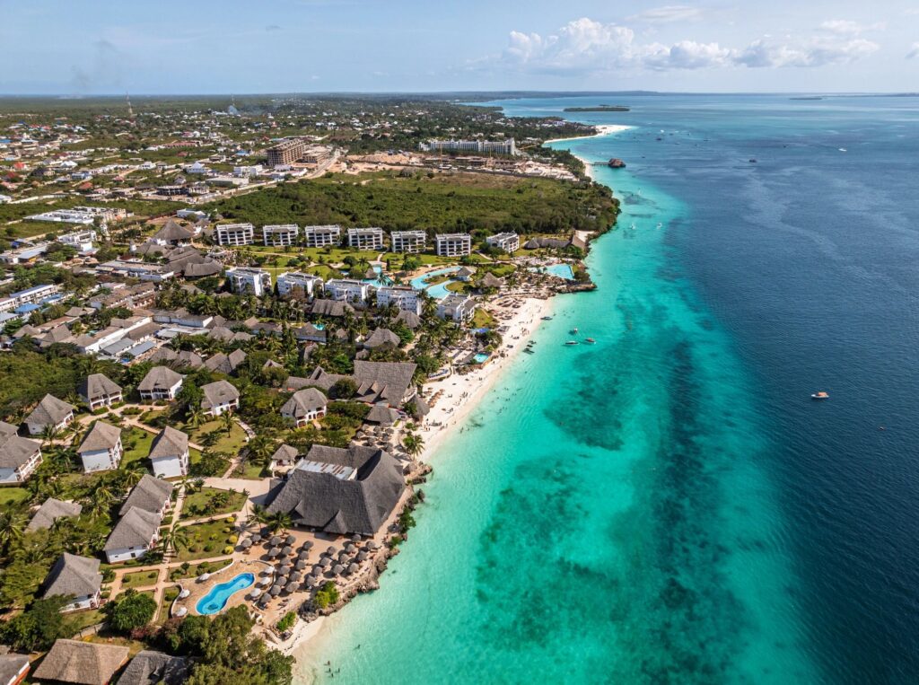 Nungwi beach resort and hotel bungalows view from above, showing luxurious tropical vacation destination along the turquoise Indian Ocean coastline in Zanzibar